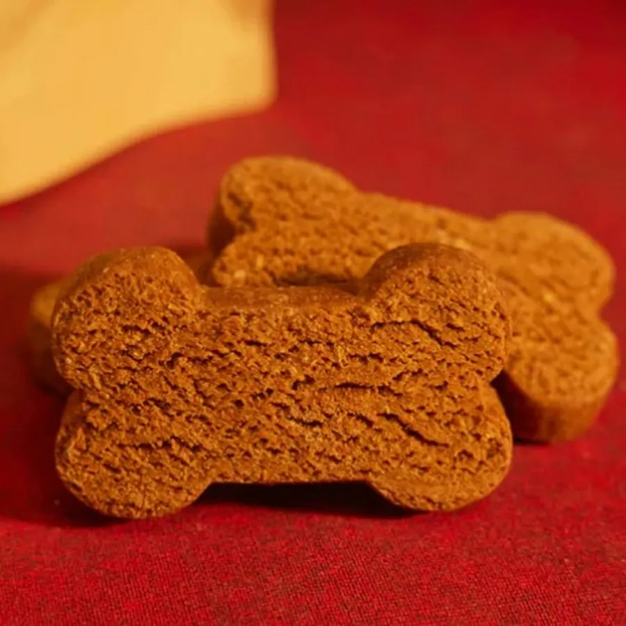 A bone-shaped biscuit on a red cloth